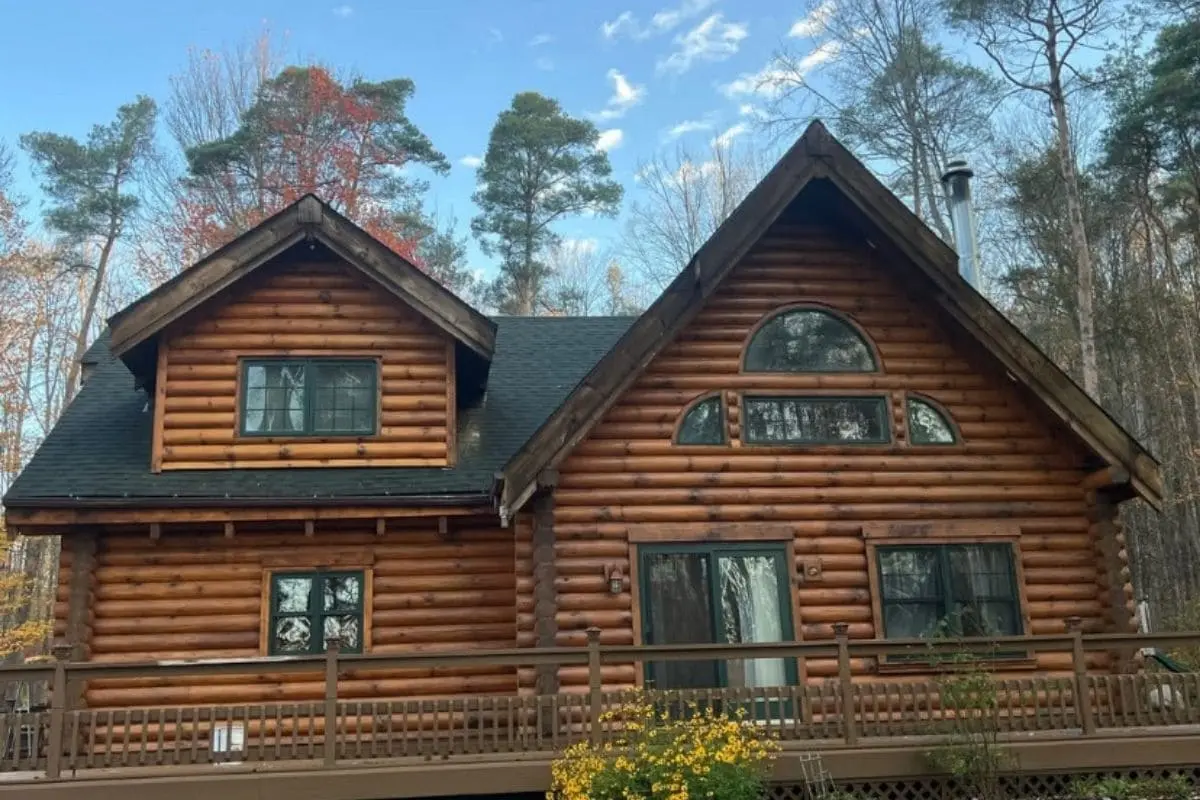 Restored log home exterior with natural timber walls and wood finishes