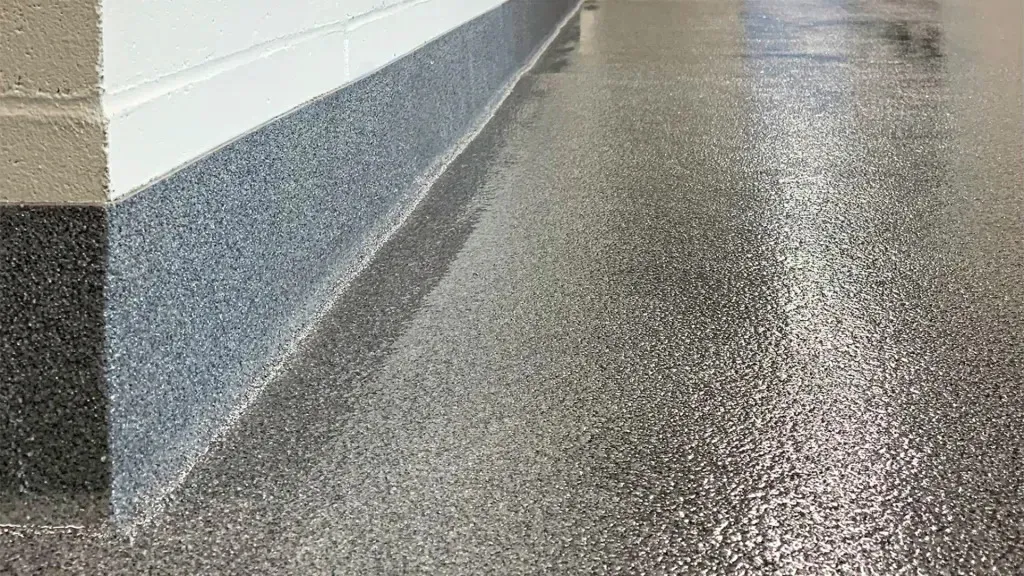 Close-up of decorative quartz mineral aggregate in a textured resin floor